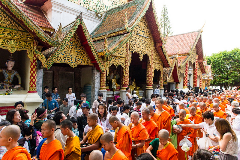 Monks Gathering at a Thai Temple at Doi Suthep temple Crowd of monks and visitors outside an ornate Thai temple with golden details at Doi Suthep temple.