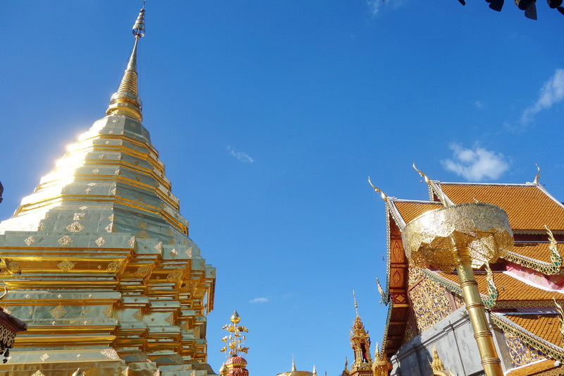 Wat Phra That Doi Suthep Architecture at Doi Suthep temple Golden temple structures with intricate designs under a clear blue sky at Doi Suthep temple.