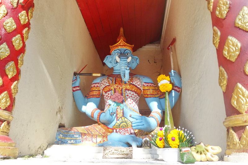 Colorful statue of a deity with an elephant head inside a temple alcove at Doi Suthep temple.