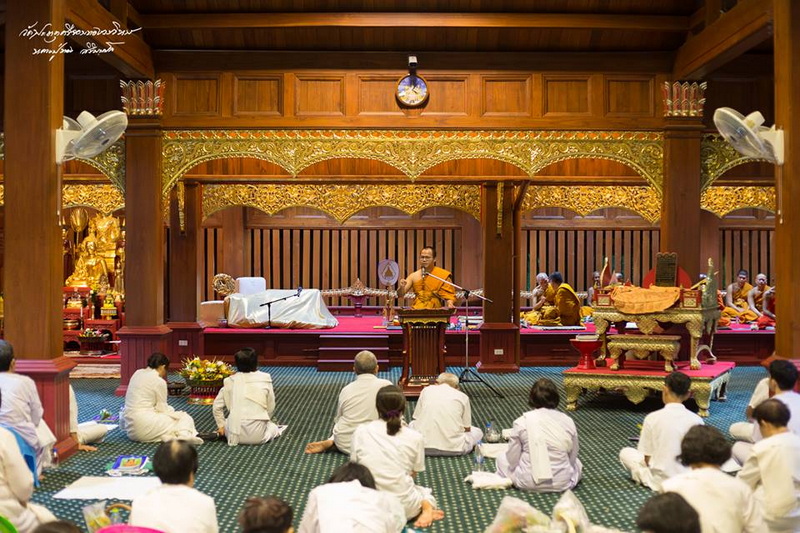 Buddhist Ceremony Inside Temple at Wat Phra That Si Chom Thong Interior of a Buddhist temple with monks and laypeople participating in a prayer ceremony at Wat Phra That Si Chom Thong.
