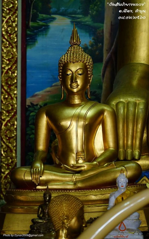 Golden Buddha Inside Temple at Wat San Pa Yang Luang Golden Buddha statue inside a temple with a painted landscape background at Wat San Pa Yang Luang.