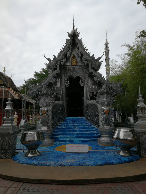 Decorative Temple Entrance at Wat Sri Suphan Ornate black temple entrance with intricate carvings and silver bowls in front at Wat Sri Suphan.