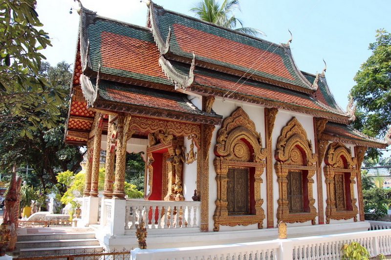 Ornate Thai Temple at Wat Suan Dok Ornate temple with intricate gold details and lush greenery around it at Wat Suan Dok.