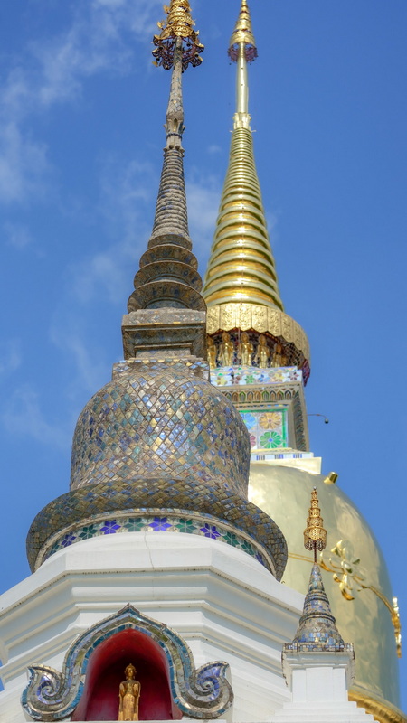 Temple Spire Close-Up at Wat Suan Dok Detailed view of golden and silver temple spires reaching into the sky at Wat Suan Dok.
