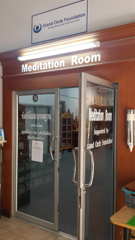 Meditation Room Entrance at Wat Suan Dok Glass doors labeled 'Meditation Room' with sign above and inner room visible through glass at Wat Suan Dok.