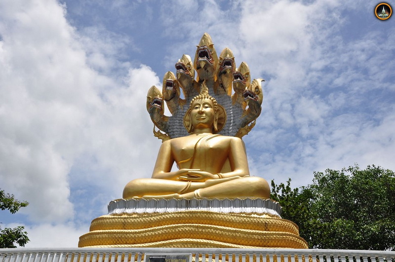 Golden Buddha with Multiple Heads at Tha Ton Temple Large golden Buddha statue with multiple heads and peaceful face under partly cloudy sky at Tha Ton Temple.