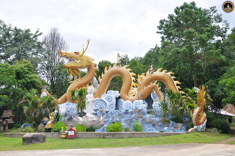 Dragon Sculpture in Garden at Wat Thaton Golden dragon statue with water and plants in a lush outdoor setting at Wat Thaton.