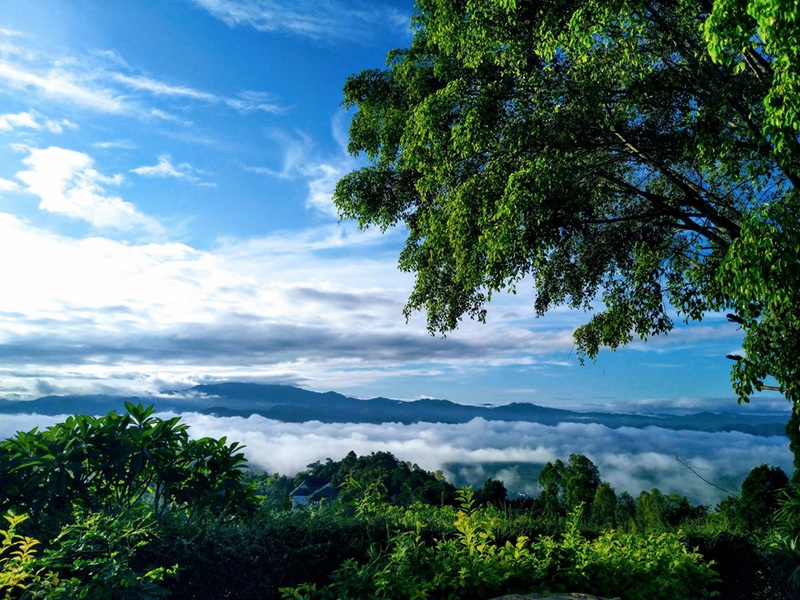 Scenic Mountain View at Wat Thaton Tree with a view of clouds and mountains under a bright blue sky at Wat Thaton.