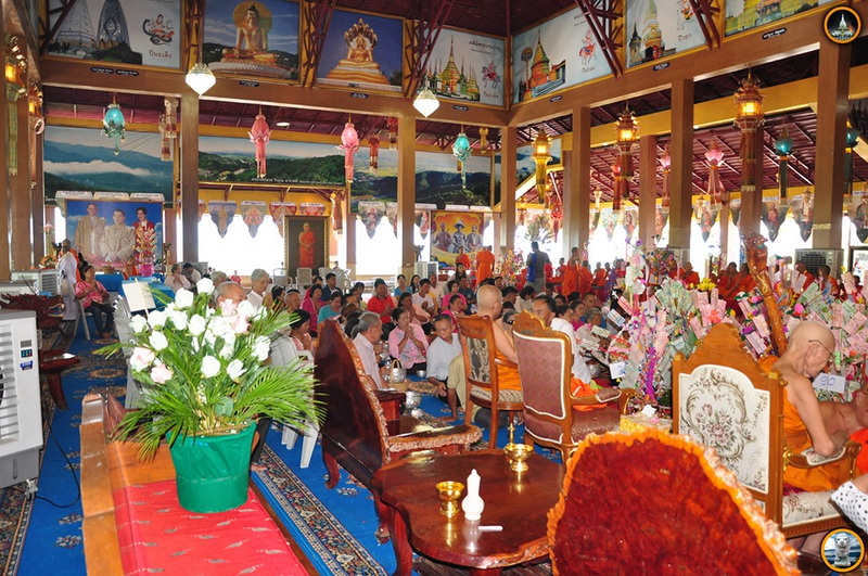 Inside a Buddhist Temple at Wat Thaton Indoor scene with monks, visitors, and colorful religious decorations and artwork at Wat Thaton.