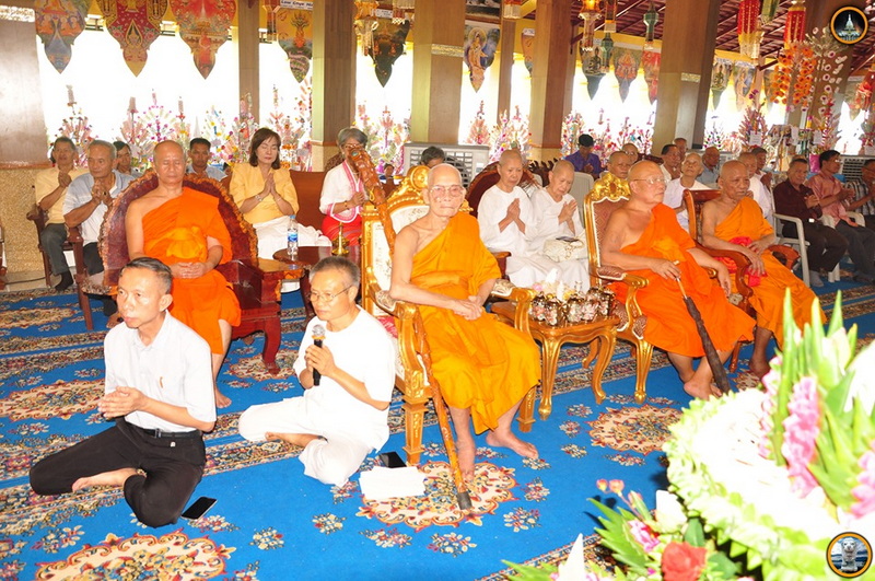 Indoor Buddhist Ceremony with Monks at Wat Thaton Monks and attendees seated in a decorated hall during a Buddhist ceremony at Wat Thaton.