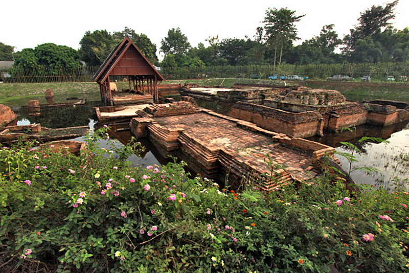 Ancient Ruins of Wiang Kum Kam Ancient brick ruins with a water mirror and lush greenery surrounding them at Wiang Kum Kam.
