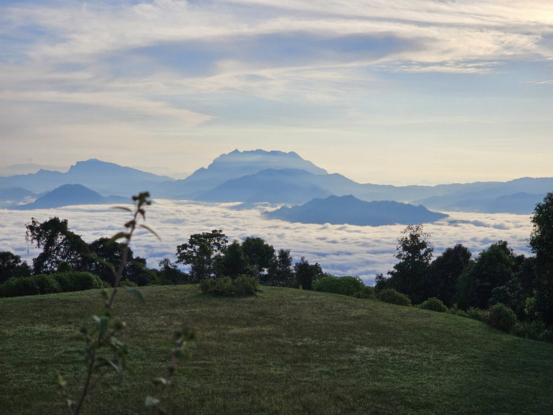 Mountain View with Clouds at Mae Hong Son Scenic mountain range with clouds and a grassy foreground under a cloudy sky at Mae Hong Son.