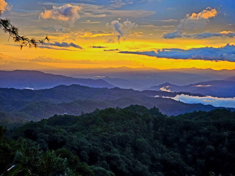 Scenic mountain layers during sunset with colorful clouds and a vibrant sky at Mae Hong Son.