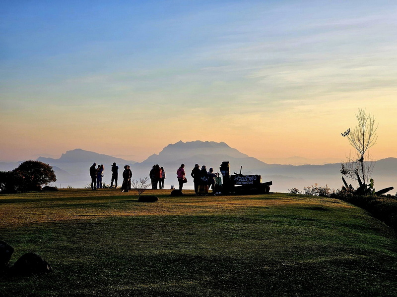 Sunset View at Hilltop at Huai Nam Dang National Park People gather on a hilltop overlooking mountains during sunset with a colorful sky at Huai Nam Dang National Park.