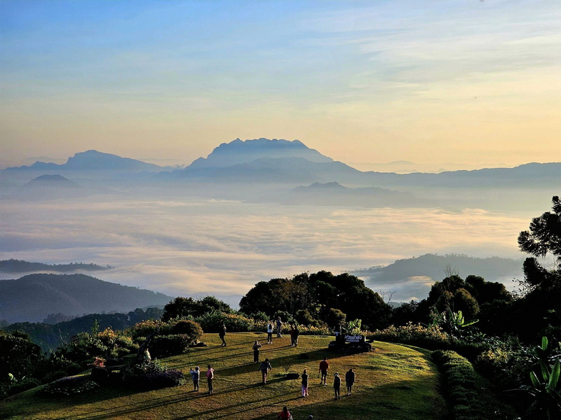 Mountain View at Sunset at Mae Hong Son Mountain landscape with clouds and people on a grassy viewpoint during sunset at Mae Hong Son.