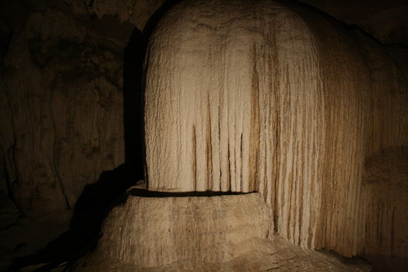 Inside view of a large stalagmite with vertical striations in a dark cave at Mae Hong Son.