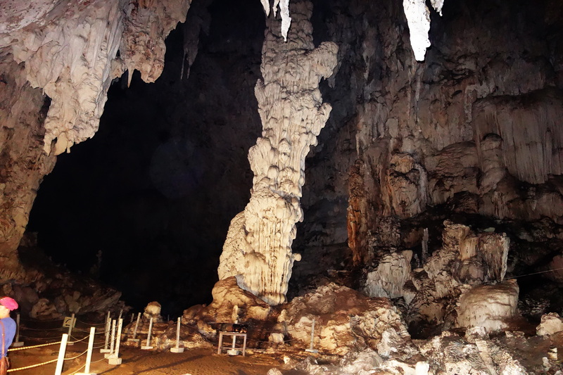 Interior of Tham Lod Cave at Mae Hong Son Inside a limestone cave with stalactites and stalagmites and a person at the edge at Mae Hong Son.