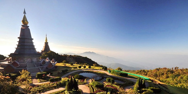 Scenic View of Pagodas and Gardens at King and Queen Pagodas Two pagodas with landscaped gardens and mountains in the background under a clear sky at King and Queen Pagodas.