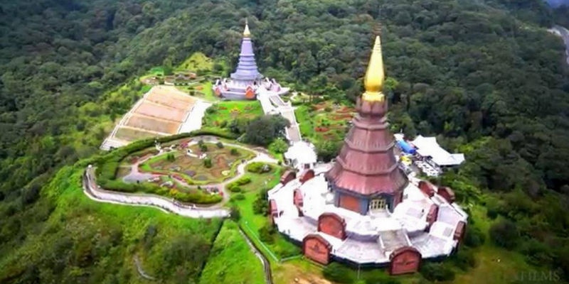 Temple Spires amid Forest Hills at Doi Inthanon National Park Aerial view of temple with tall spires surrounded by green forest hills at Doi Inthanon National Park.