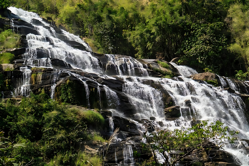 Mae Ya Waterfall Water flowing over rocks in a lush forest setting at Mae Ya Waterfall, Mae Ya Waterfall main article view 2 2