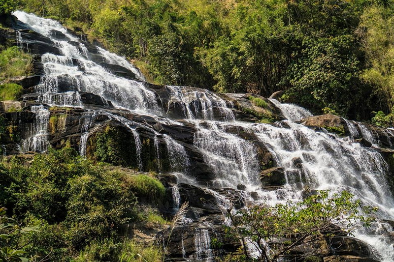 Serene Waterfall in Nature at Doi Inthanon National Park Water flowing over rocks in a lush forest setting at Doi Inthanon National Park.