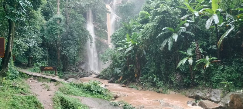 Tropical Forest Waterfall at Doi Suthep-Pui National Park Waterfall flowing into a rocky stream surrounded by dense tropical forest at Doi Suthep-Pui National Park.