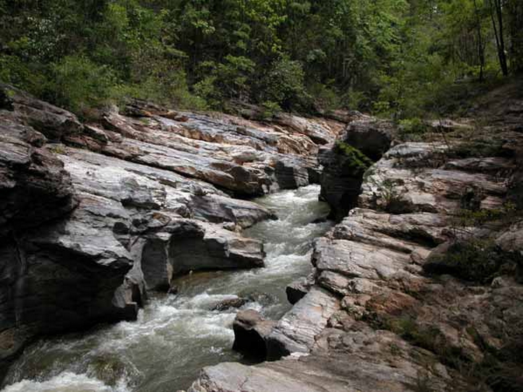 Scenic Rocky Canyon with Flowing Water at Ob Khan National Park Stream flowing through rocky canyon with lush green trees around it at Ob Khan National Park.