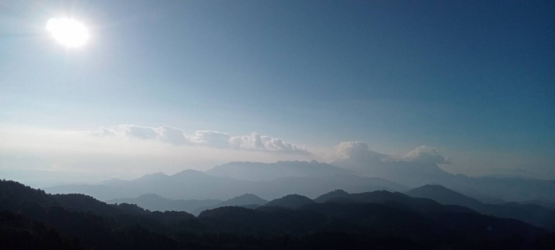 Mountain Range View at Pha Daeng National Park Scenic mountain landscape with layers of mountains and a partly cloudy sky at Pha Daeng National Park.