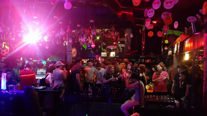 Nightlife in a vibrant club at Things To Do In Chiang Mai Evening People enjoying nightlife with colorful lights and decorations in a nightclub at Things To Do In Chiang Mai Evening.