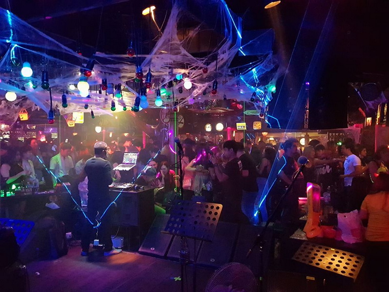 Crowded nightclub with vibrant lighting and people enjoying the night scene at Chiang Mai Nightlife.