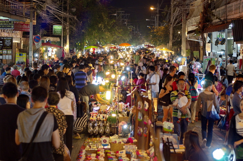 Busy Night Market Scene at Nightlife In Chiang Mai Old City Night market with crowded stalls, vendors, and bright lighting in Chiang Mai at Nightlife In Chiang Mai Old City.
