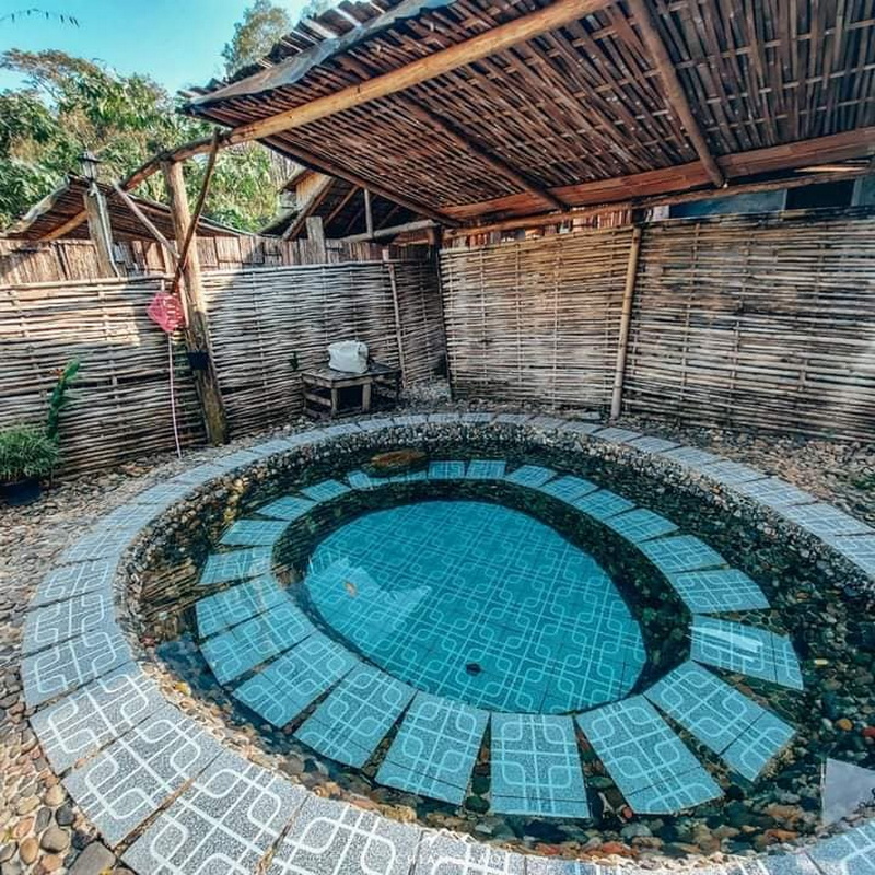 Circular mineral hot spring pool at Ban Yang Pu Toh with a bamboo roof at Ban Yang Pu Toh mineral hotsprings.