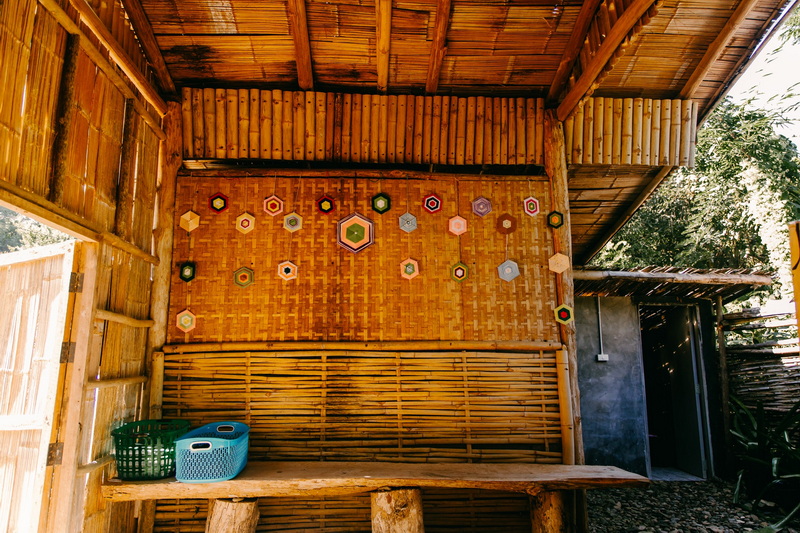 Decorative Bamboo Structure Interior at Ban Yang Pu Toh mineral hotsprings Bamboo-walled room with colorful decorations and a small table at Ban Yang Pu Toh mineral hotsprings.