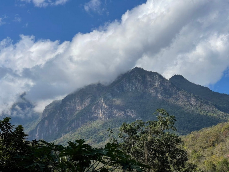 Mountain with Cloud Cover at Ban Yang Pu Toh Majestic mountain peak covered with clouds and surrounded by greenery at Ban Yang Pu Toh.