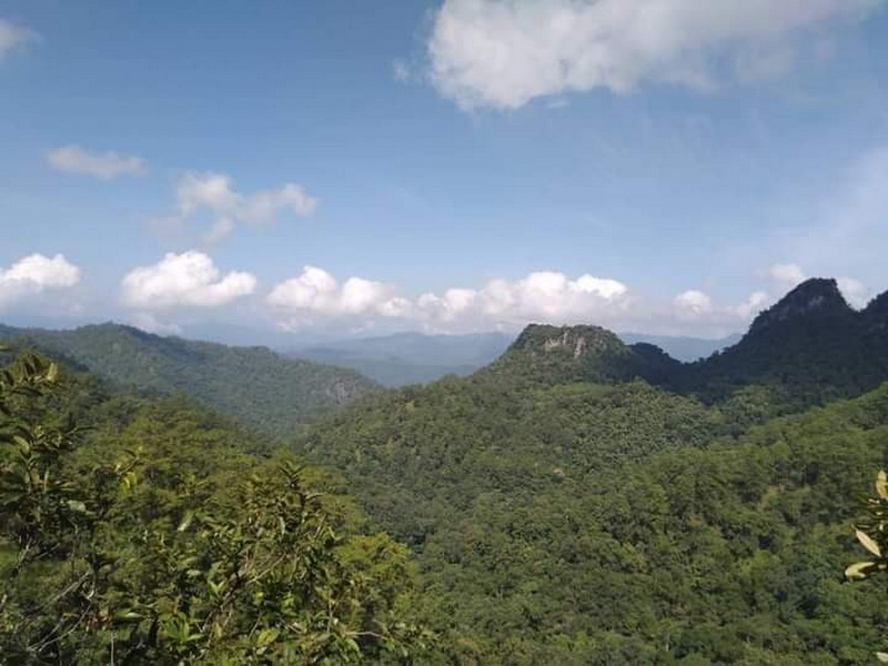 Scenic Mountain Landscape at Ban Yang Pu Toh Wide view of green mountains with blue sky and clouds above at Ban Yang Pu Toh.