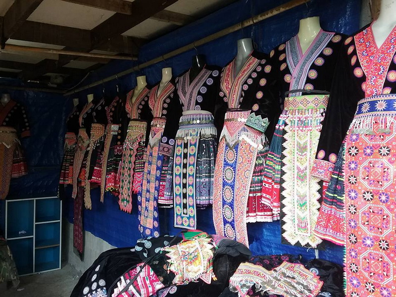 Traditional Embroidered Clothing Display at Doi Pui Hmong Village Mannequins showcase vibrant embroidered traditional clothing inside a stall at Doi Pui Hmong Village.