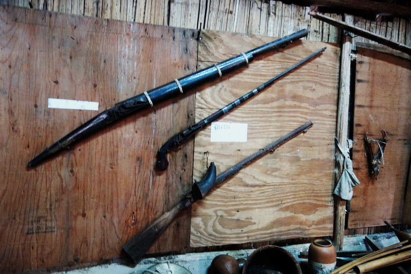 Three traditional spears mounted on a wooden wall inside a rustic room at Hmong Doi Pui Village.