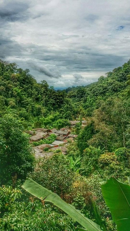 Green Valley with Village and Cloudy Sky at Ban Mae Kanpong View of a verdant valley with houses among trees and a cloudy sky above at Ban Mae Kanpong.