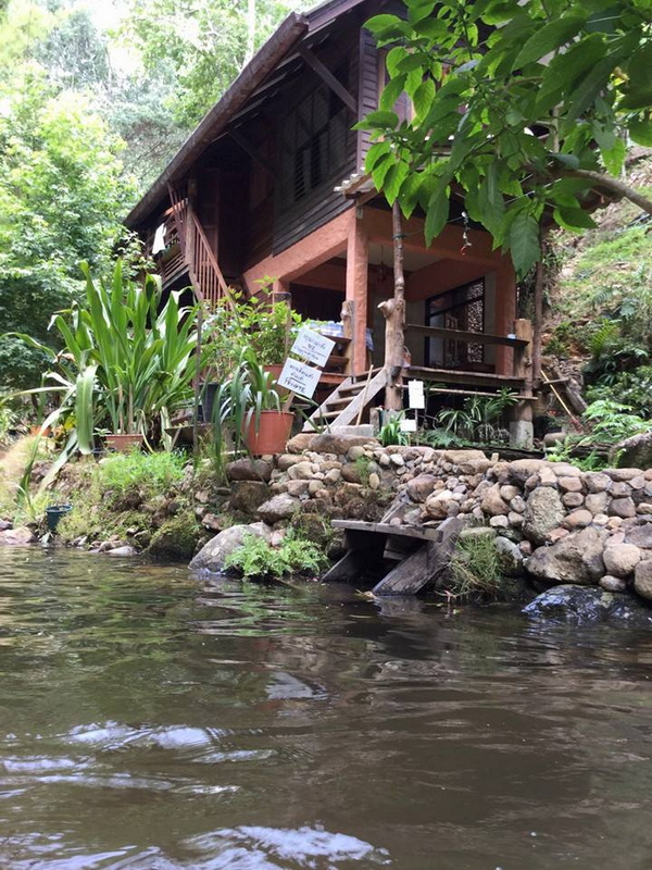 Streamside Wooden House at Ban Mae Kanpong Wooden house on stilts beside a flowing stream in a dense forest at Ban Mae Kanpong.