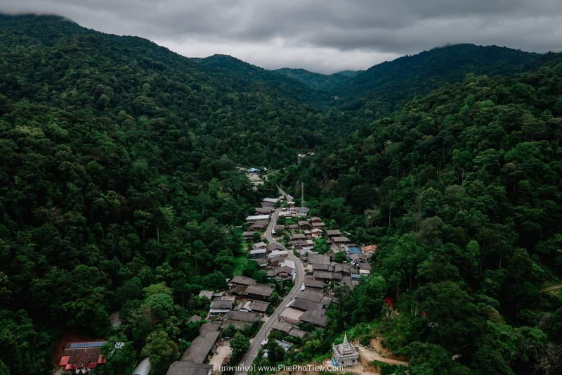 Scenic Mountain Village View at Pang Hi Village Aerial view of a village in a green mountainous valley with winding roads and forests at Pang Hi Village.