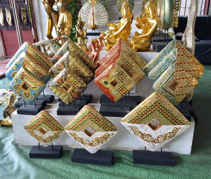 Traditional Thai Decorative Crafts at San Kamphaeng Village Colorful Thai decorative trinkets with gold statues in the background at San Kamphaeng Village.